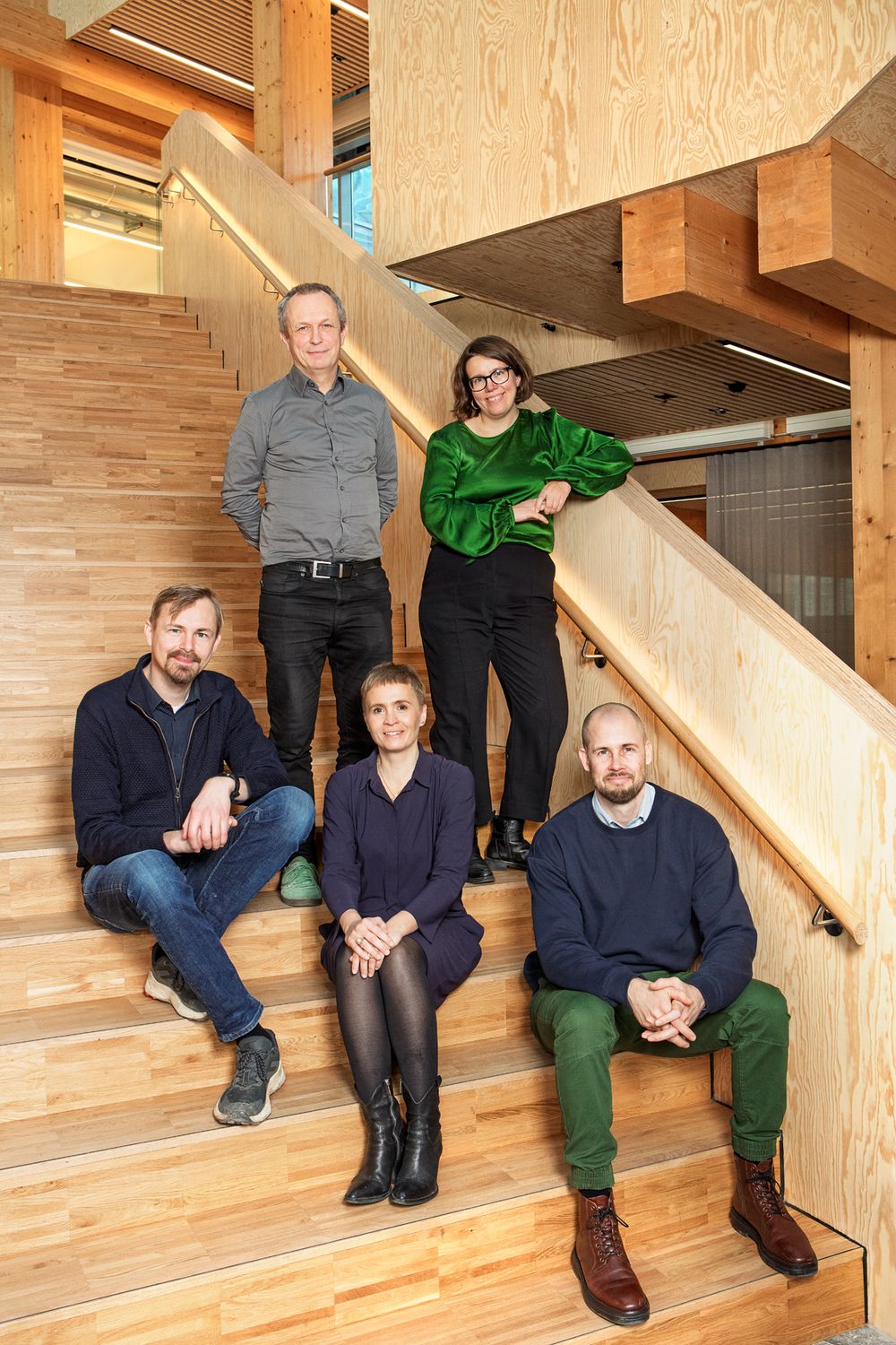 The five founding partners of Prenaital on a wooden staircase
